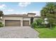 House with tile roof, two-car garage, and landscaped yard at 13215 Ramblewood Trl, Bradenton, FL 34211