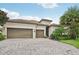 House with tile roof, two-car garage, and landscaped yard at 13215 Ramblewood Trl, Bradenton, FL 34211