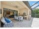 Outdoor living space with seating, grill, and pool view at 13215 Ramblewood Trl, Bradenton, FL 34211
