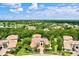 Aerial view of an estate home with a well-manicured lawn, landscaping and mature trees at 13215 Palmers Creek Ter, Lakewood Ranch, FL 34202