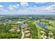 Stunning aerial view of a golf course community with lush greenery, serene lakes, and beautiful homes at 13215 Palmers Creek Ter, Lakewood Ranch, FL 34202
