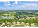 Aerial view of a golf course community with mature trees and scenic lakes at 13215 Palmers Creek Ter, Lakewood Ranch, FL 34202