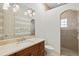 This bathroom showcases a vanity, toilet, and tiled shower with glass block window at 13215 Palmers Creek Ter, Lakewood Ranch, FL 34202