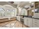 Elegant bathroom featuring a soaking tub with natural light and white vanities at 13215 Palmers Creek Ter, Lakewood Ranch, FL 34202