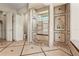 Luxurious walk-in shower is fully tiled with a built-in bench, and multiple shower heads at 13215 Palmers Creek Ter, Lakewood Ranch, FL 34202
