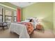 Bright bedroom with a large window and a colorful floral comforter at 13215 Palmers Creek Ter, Lakewood Ranch, FL 34202