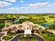 Impressive clubhouse with meticulously manicured landscaping and circular driveway in a beautiful community at 13215 Palmers Creek Ter, Lakewood Ranch, FL 34202