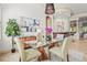 Inviting dining room with a glass table, stylish light fixture, artwork, and view of the bar area at 13215 Palmers Creek Ter, Lakewood Ranch, FL 34202