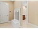 Entryway with hall tree and tile flooring with view to an adjacent bathroom at 13215 Palmers Creek Ter, Lakewood Ranch, FL 34202