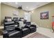 A home theater with reclining seating, a projector screen, and decor at 13215 Palmers Creek Ter, Lakewood Ranch, FL 34202
