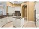 Well-appointed kitchen boasts custom cabinets, granite countertops, and a center island for modern convenience at 13215 Palmers Creek Ter, Lakewood Ranch, FL 34202