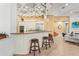 Modern kitchen with a breakfast bar, pendant lighting, stainless steel appliances, and open floor plan at 13215 Palmers Creek Ter, Lakewood Ranch, FL 34202
