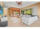 Spacious living room with bar area and large sliding glass doors at 13215 Palmers Creek Ter, Lakewood Ranch, FL 34202