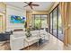 Comfortable living room with tile floors, a ceiling fan, and sliding doors to the outdoors at 13215 Palmers Creek Ter, Lakewood Ranch, FL 34202