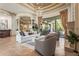 Bright living room with a fireplace, chandelier, columns, and a view of the backyard at 13215 Palmers Creek Ter, Lakewood Ranch, FL 34202