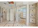 Elegant primary bathroom with tiled shower, bench, double shower heads, and a private toilet room at 13215 Palmers Creek Ter, Lakewood Ranch, FL 34202