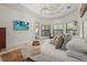 Spacious main bedroom with a chandelier and large windows overlooking the lush landscaping at 13215 Palmers Creek Ter, Lakewood Ranch, FL 34202