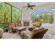 Cozy screened-in patio with a fireplace and comfortable wicker furniture overlooking the pool at 13215 Palmers Creek Ter, Lakewood Ranch, FL 34202