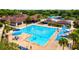 Relaxing community pool area with lap lanes, blue umbrellas, and comfortable lounge chairs at 13215 Palmers Creek Ter, Lakewood Ranch, FL 34202