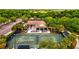 Aerial view of well-kept tennis court, club house, and parking area in lush community at 13215 Palmers Creek Ter, Lakewood Ranch, FL 34202