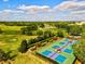 Overhead view of well-maintained tennis courts surrounded by beautiful landscaping in a vibrant community at 13215 Palmers Creek Ter, Lakewood Ranch, FL 34202