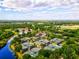 Aerial shot of multiple tennis courts nestled within a lush, green community surrounded by a blue river at 13215 Palmers Creek Ter, Lakewood Ranch, FL 34202