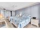 Bedroom featuring twin beds, wicker furniture, light-colored walls, and a view into the hallway at 1602 Stickney Point Rd # 305, Sarasota, FL 34231