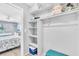 Closet with shelving to the bedroom. The bedroom has twin beds and views of the water at 1602 Stickney Point Rd # 305, Sarasota, FL 34231