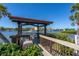 Community dock with canopy and seating overlooking the bay at 1602 Stickney Point Rd # 305, Sarasota, FL 34231
