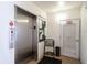 A stainless steel elevator with a bulletin board on the wall and a utility door at 1602 Stickney Point Rd # 305, Sarasota, FL 34231