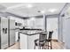 Kitchen featuring stainless steel appliances, granite countertops, and a breakfast bar at 1602 Stickney Point Rd # 305, Sarasota, FL 34231