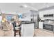Bright kitchen features stainless steel appliances, a breakfast bar, and views of the living area and the water beyond at 1602 Stickney Point Rd # 305, Sarasota, FL 34231