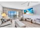 A living room featuring comfortable seating with stunning view and ceiling fan at 1602 Stickney Point Rd # 305, Sarasota, FL 34231