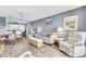 A living room featuring comfortable seating, dining area, and updated lighting fixtures at 1602 Stickney Point Rd # 305, Sarasota, FL 34231