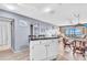 A living room featuring seating and dining area with updated flooring and fixtures at 1602 Stickney Point Rd # 305, Sarasota, FL 34231