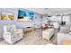 A living room with combined seating and dining area and updated lighting fixtures at 1602 Stickney Point Rd # 305, Sarasota, FL 34231