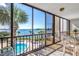 Screened patio with water view, showing lounge seating and tropical landscaping by the community pool at 1602 Stickney Point Rd # 305, Sarasota, FL 34231