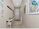 Hallway showcases coastal decor, neutral paint, tiled floor, and a decorative accent table at 5010 Tivoli Run, Bradenton, FL 34211