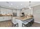 Well-lit kitchen featuring stainless steel appliances, granite countertops, and center island with seating at 5010 Tivoli Run, Bradenton, FL 34211