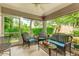 Cozy screened porch with wicker furniture at 4098 Fairway Pl, North Port, FL 34287