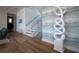 Elegant hallway with hardwood floors, statement art piece, and staircase at 3702 5Th Ave, Holmes Beach, FL 34217