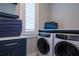 Bright laundry room with stackable washer and dryer at 3702 5Th Ave, Holmes Beach, FL 34217