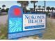 Nokomis Beach sign depicting beach scene and restroom information at 90 Inlets Blvd # 90, Nokomis, FL 34275