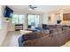 Spacious living room featuring a sectional sofa and access to a lanai at 177 Vinadio Blvd, Nokomis, FL 34275