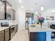 Modern kitchen with island, stainless steel appliances, and granite countertops at 177 Vinadio Blvd, Nokomis, FL 34275