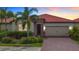 Single-Gathering home with two-car garage and landscaped front yard at 177 Vinadio Blvd, Nokomis, FL 34275