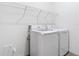 Bright laundry room with washer, dryer, and ample shelving at 177 Vinadio Blvd, Nokomis, FL 34275