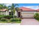 Single story home with brick driveway and landscaping at 177 Vinadio Blvd, Nokomis, FL 34275