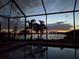 Relaxing pool area with stunning sunset views over the lake at 177 Vinadio Blvd, Nokomis, FL 34275