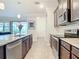 Modern kitchen with stainless steel appliances and granite countertops at 177 Vinadio Blvd, Nokomis, FL 34275